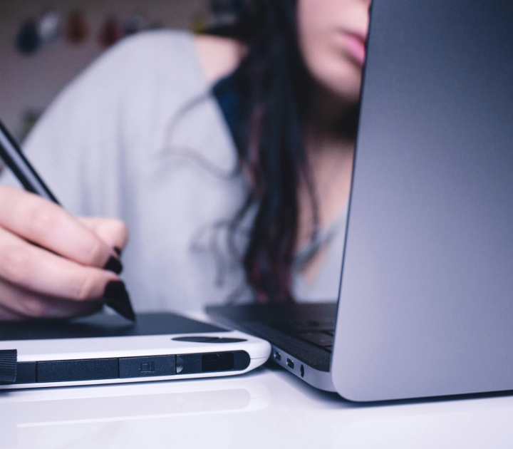 Student taking notes with an assistive technology device