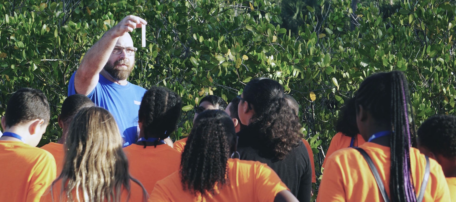 Teacher shows test tube to students